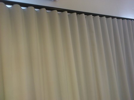 Wave curtains on decorative rod.
